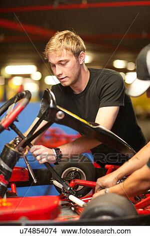 Mechanics repairing go cart View Large Photo Image Picture - Mechanics repairing go cart. Fotosearch