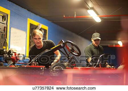 Mechanics working on go cart in workshop View Large Photo Image Picture - Mechanics working on go cart in workshop. Fotosearch