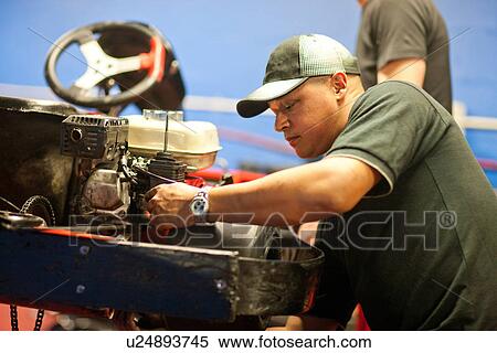 Stock Photography - Mechanics working on go cart. Fotosearch