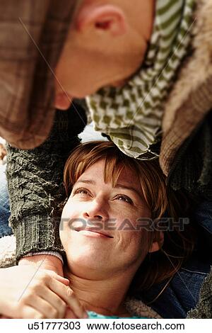 Stock Image - Mid adult couple face to face. Fotosearch
