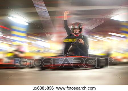 Mid adult woman driving go cart View Large Photo Image Stock Photograph - Mid adult woman driving go cart. Fotosearch