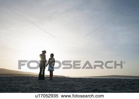 Mother and daughter holding hands on beach View Large Photo Image Stock Photography - Mother and daughter holding hands on beach. Fotosearch