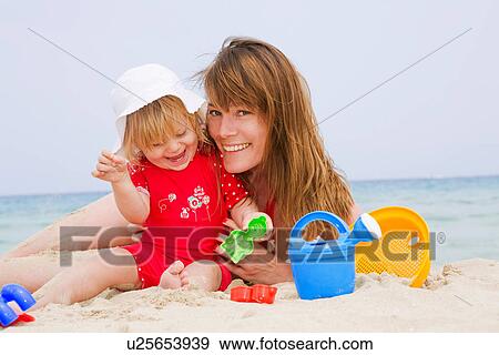 Mother and daughter playing on beach View Large Photo Image Stock Photo - Mother and daughter playing on beach. Fotosearch