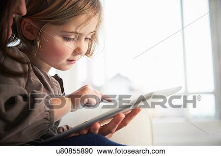 Stock Image - Mother and daughter using digital tablet. Fotosearch