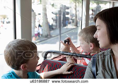 Mother and sons on double decker bus in London View Large Photo Image Stock Photo - Mother and sons on double decker bus in London. Fotosearch