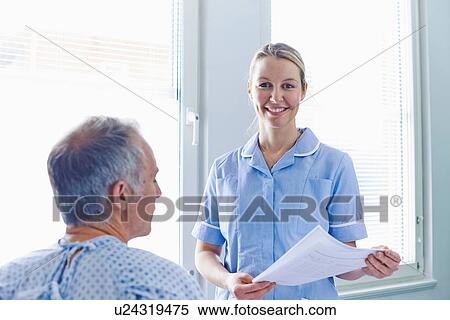 Nurse having conversation with patient View Large Photo Image Stock Photography - Nurse having conversation with patient. Fotosearch