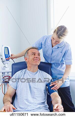 Nurse taking patient's blood pressure View Large Photo Image Stock Image - Nurse taking patient's blood pressure. Fotosearch