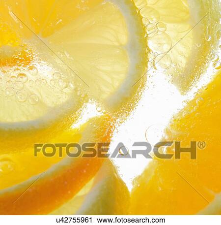 Stock Image - Orange wedges in bubbly water. Fotosearch
