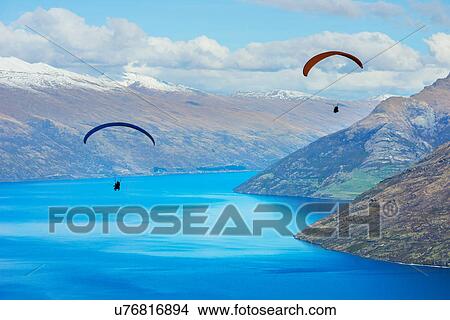 Paragliding over Lake Wakatipu, Queenstown, South Island, New Zealand View Large Photo Image Picture - Paragliding over Lake Wakatipu, Queenstown, South Island, New Zealand. Fotosearch