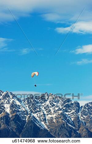 Paragliding over Remarkables Mountain Range, Queenstown, South Island, New Zealand View Large Photo Image Stock Photo - Paragliding over Remarkables Mountain Range, Queenstown, South Island, New Zealand. Fotosearch