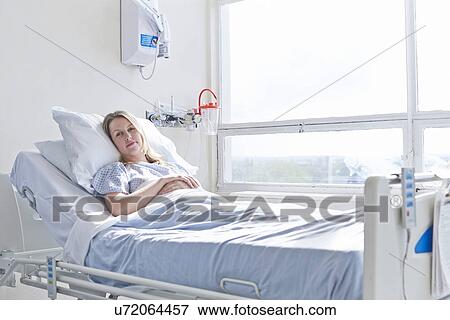 Patient lying in hospital bed View Large Photo Image Stock Photo - Patient lying in hospital bed. Fotosearch