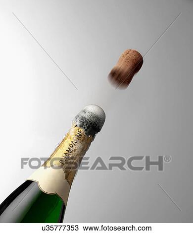 Stock Image - Popping Champagne bottle. Fotosearch