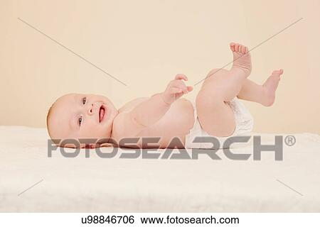 Portrait of baby kicking View Large Photo Image Stock Photograph - Portrait of baby kicking. Fotosearch
