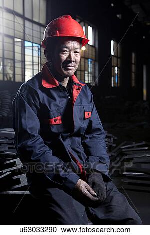 Stock Image - Portrait of man working in cast iron foundry. Fotosearch