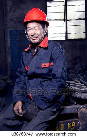 Portrait of man working in cast iron foundry View Large Photo Image Stock Photo - Portrait of man working in cast iron foundry. Fotosearch