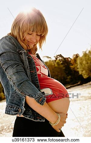Portrait of pregnant woman looking down View Large Photo Image Stock Image - Portrait of pregnant woman looking down. Fotosearch