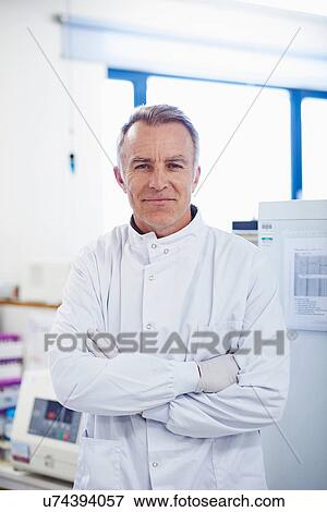 Portrait of researcher standing in lab wearing lab coat View Large Photo Image Stock Photo - Portrait of researcher standing in lab wearing lab coat. Fotosearch