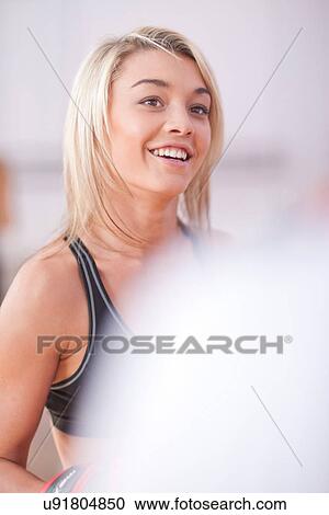 Portrait of young woman in gym View Large Photo Image Stock Image - Portrait of young woman in gym. Fotosearch