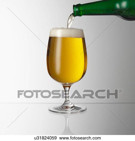 Stock Photo - Pouring beer into glass. Fotosearch