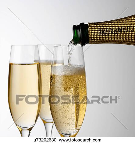 Pouring Champagne into glass View Large Photo Image Stock Image - Pouring Champagne into glass. Fotosearch