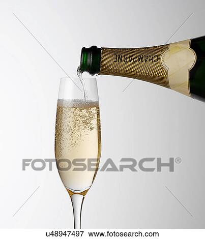 Pouring Champagne into glass View Large Photo Image Stock Photo - Pouring Champagne into glass. Fotosearch