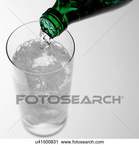 Stock Image - Pouring sparkling water into glass. Fotosearch