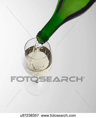 Pouring white wine into glass View Large Photo Image Stock Photo - Pouring white wine into glass. Fotosearch