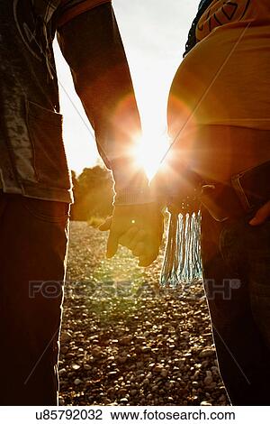 Pregnant woman and partner holding hands View Large Photo Image Stock Image - Pregnant woman and partner holding hands. Fotosearch