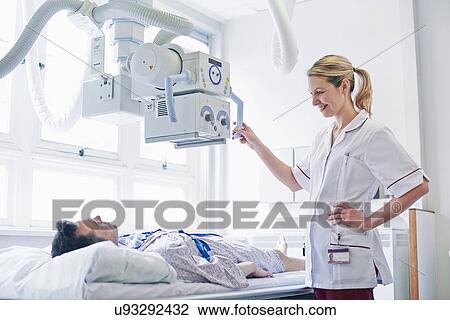 Stock Image - Radiologist scanning patient. Fotosearch