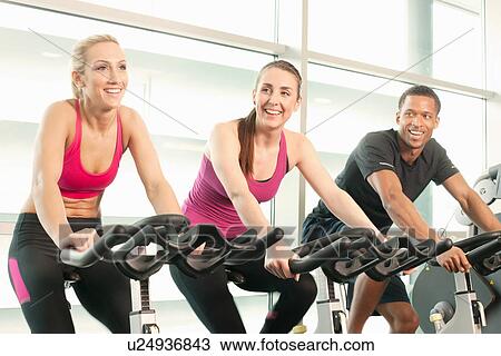 Riding exercise bikes View Large Photo Image Stock Image - Riding exercise bikes. Fotosearch