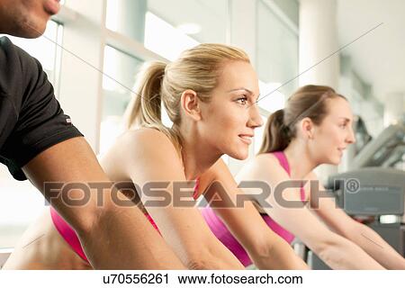 Riding exercise bikes View Large Photo Image Stock Image - Riding exercise bikes. Fotosearch