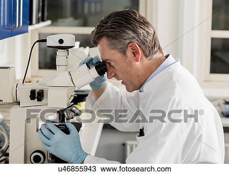 Scientist using microscope View Large Photo Image Stock Image - Scientist using microscope. Fotosearch