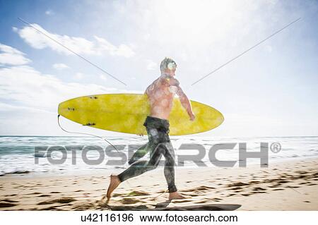 Stock Photograph - Surfer running with surfboard. Fotosearch