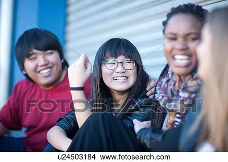 Picture - Teenage friends laughing. Fotosearch