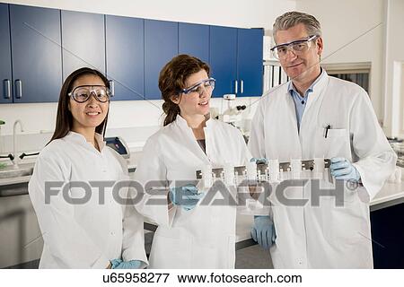 Three scientists in laboratory View Large Photo Image Stock Photo - Three scientists in laboratory. Fotosearch