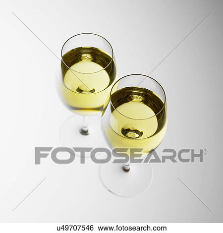 Two glasses of white wine View Large Photo Image Stock Photograph - Two glasses of white wine. Fotosearch