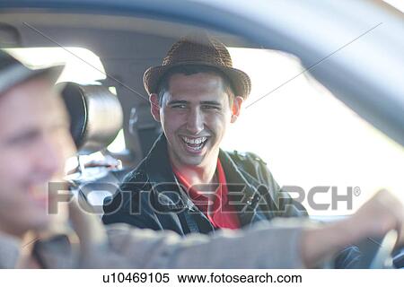 Stock Photography - Two young men driving in car. Fotosearch