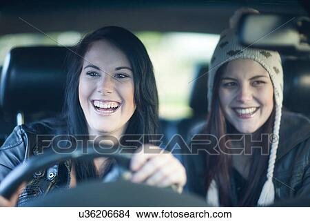 Picture - Two young women driving. Fotosearch