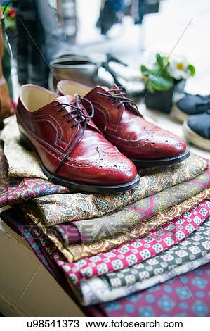 Stock Image - Vintage men's shoes on top of pile of fabric. Fotosearch