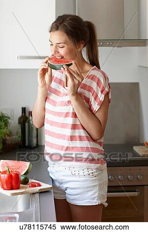 Woman biting slice of watermelon View Large Photo Image Stock Photography - Woman biting slice of watermelon. Fotosearch