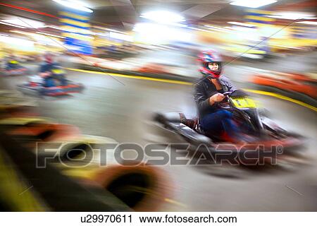 Woman driving go cart on track View Large Photo Image Stock Image - Woman driving go cart on track. Fotosearch