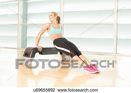 Woman exercising on step View Large Photo Image Stock Image - Woman exercising on step. Fotosearch