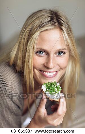 Woman holding bruschetta to mouth View Large Photo Image Stock Photo - Woman holding bruschetta to mouth. Fotosearch