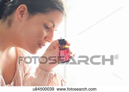 Woman holding glass bottle View Large Photo Image Stock Photo - Woman holding glass bottle. Fotosearch