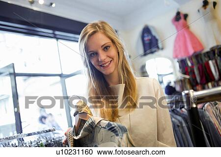 Woman holding top garment and scarf View Large Photo Image Stock Image - Woman holding top garment and scarf. Fotosearch