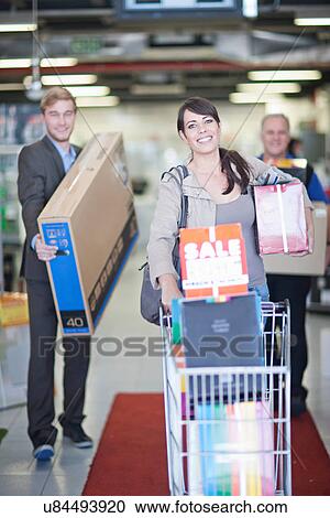 Woman leaving showroom with abundance of purchases View Large Photo Image Stock Image - Woman leaving showroom with abundance of purchases. Fotosearch