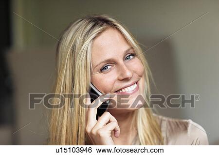 Woman listening to mobile phone View Large Photo Image Stock Photograph - Woman listening to mobile phone. Fotosearch