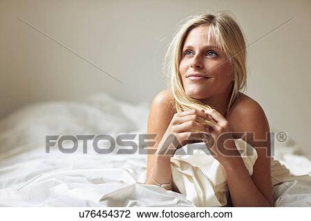 Stock Image - Woman lying on stomach. Fotosearch