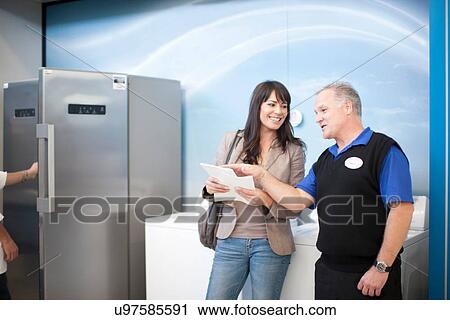 Woman negotiating with salesman in showroom View Large Photo Image Stock Image - Woman negotiating with salesman in showroom. Fotosearch