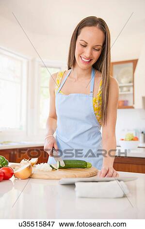 Woman preparing vegetables for meal View Large Photo Image Stock Photo - Woman preparing vegetables for meal. Fotosearch